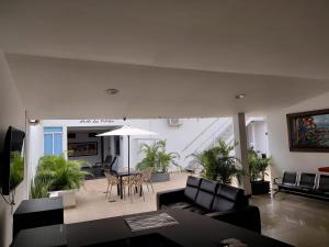 a living room with a table and chairs at Hotel Los Potrillos in Aguazul