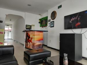 a living room with a large fish tank on the wall at Hotel Los Potrillos in Aguazul +13 photos
