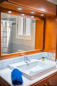 a bathroom with a sink and a mirror at Villa Stella with Jacuzzi in Oroklini +50 photos