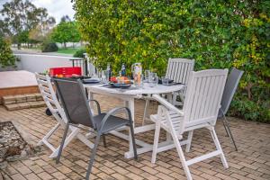 a white table and chairs on a patio at Villa Stella with Jacuzzi in Oroklini