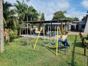a playground with a swing set in a yard at Boskraai Self-Catering -74 Hornbill Street in St Lucia