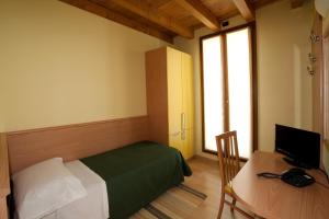 Postel nebo postele na pokoji v ubytování Hotel Valbrenta + 37 fotografií
