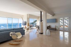a living room with a blue couch and chairs at Villa Eze Vue Mer in Éze