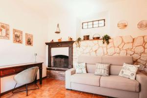 a living room with a couch and a fireplace at La casa di Solcio - Lakeside srl L&B in Lesa