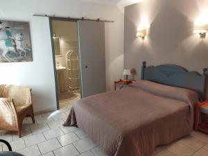 a bedroom with a bed and a bathroom at Chambres d'hôtes Mas Lassagne in Vagnas