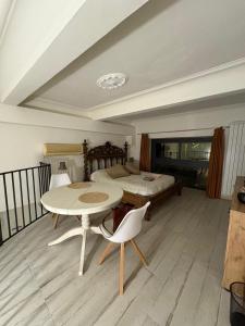 a bedroom with a bed and a table and chairs at Palazzo Bosco in Cosenza