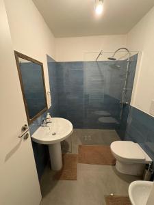 a bathroom with a sink and a toilet and a shower at Palazzo Bosco in Cosenza