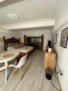 a bedroom with a bed and a desk and a table at Palazzo Bosco in Cosenza