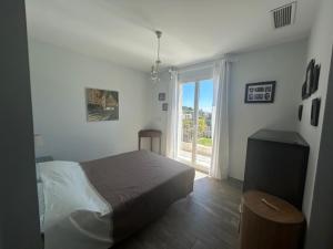 a bedroom with a bed and a large window at A True Paradise for unforgettable vacation – Villa Pool and Sea View in Nice +85 photos