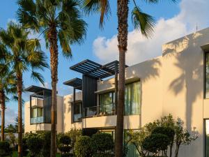 a building with palm trees in front of it at STORY Rabat in Rabat