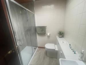 a bathroom with a shower and a toilet and a sink at The Old Manse B&B in Thurso +37 photos