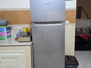 a stainless steel refrigerator in a kitchen at Appartement familial شقة للعائلة in Meknès