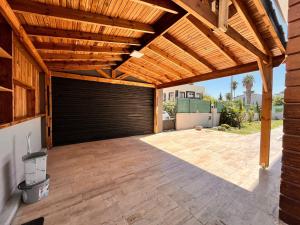 a wooden garage with a wooden pergola at canyon villa in Kemer
