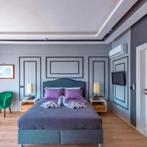 a bedroom with a blue bed with purple walls at canyon villa in Kemer +30 photos