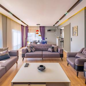a living room with a couch and a table at canyon villa in Kemer