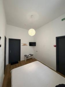 a bedroom with a white bed and a television at Atlas Hotel in Poltava