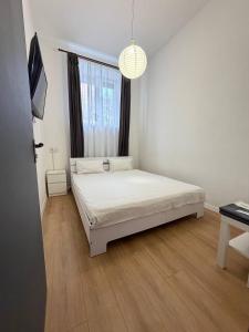 a bedroom with a bed in a room with a window at Atlas Hotel in Poltava
