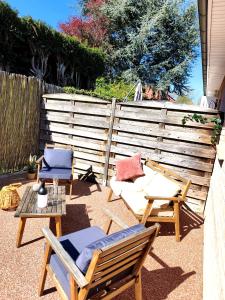 a patio with chairs and tables and a fence at Trésor de Beaurains in Beaurains