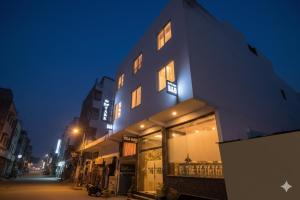 a building on a street at night with lights at Hotel DSR Park Near igi Airport Delhi in Majhera