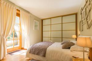 a bedroom with a large bed and a window at Gîte G175 in Grosville