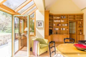 a conservatory with a table and chairs in a room at Gîte G175 in Grosville
