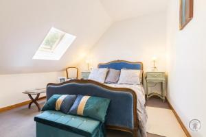 a bedroom with a bed and a chair at Gîte G1255 in Tribehou