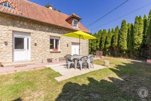 a patio with a table and chairs and a yellow umbrella at Gîte G1255 in Tribehou