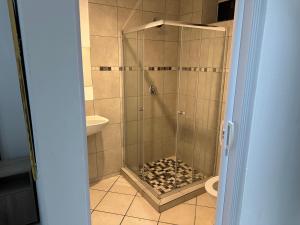 a shower stall in a bathroom with a toilet at Eagle Empire in Vereeniging +17 photos