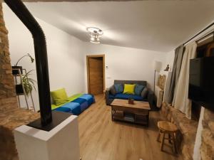 a living room with a couch and a table at Mas Lloretó - El Rossinyol in Copóns