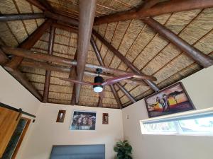 a ceiling fan in a room with wooden beams at Fynbos & Pinot Guest Cottage in Kuilsrivier