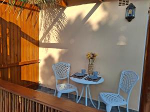 a table and two chairs on a porch with a table at Fynbos & Pinot Guest Cottage in Kuilsrivier