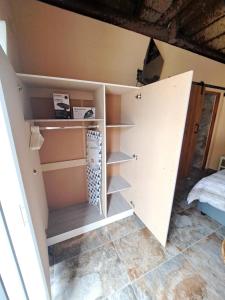 a room with a closet with shelves in it at Fynbos & Pinot Guest Cottage in Kuilsrivier +10 photos
