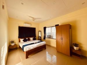a bedroom with a bed and a large window at Royal Inn in Mysore +50 photos