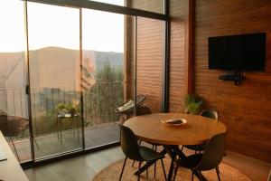 a dining room with a table and chairs and a large window at Casa de Sobreiros in Amarante