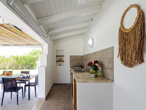 a kitchen and dining room with a table and chairs at Villa Kika by holiday World in Ispica