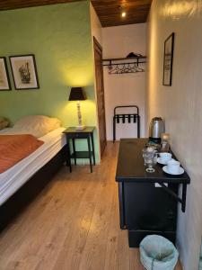a bedroom with a bed and a table with a table at Guest room with a mountain view in Laugarvatn