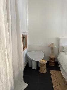 a white room with a bed and a white curtain at A Casa Di Rose in Ajaccio