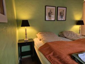 a bedroom with two beds and a lamp on a table at Guest room with a mountain view in Laugarvatn