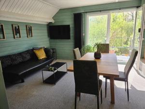 a living room with a table and a couch at StayTommy in Bertem