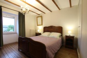 a bedroom with a bed and a window and a chandelier at Gîte G337 in Quibou