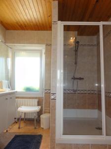 a bathroom with a shower with a glass door at Gîte G337 in Quibou