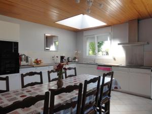 a kitchen with a table and a kitchen with a ceiling at Gîte G337 in Quibou
