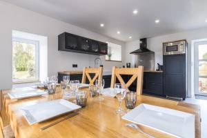 a dining room with a table with wine glasses on it at Gîte G593 in Le Val-Saint-Père +14 photos