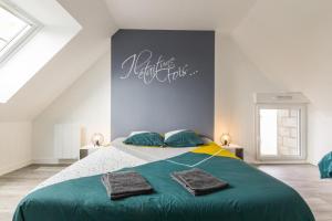 a bedroom with a large bed with green sheets and pillows at Gîte G593 in Le Val-Saint-Père