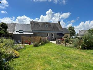 a house with a grass yard in front of it at Gîte G593 in Le Val-Saint-Père
