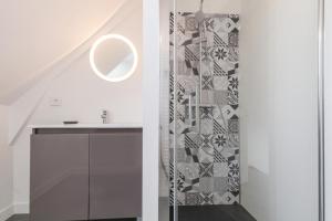 a bathroom with a sink and a shower at Gîte G593 in Le Val-Saint-Père