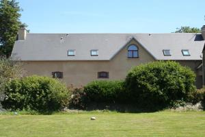 a large house with bushes in front of it at Gîte G40 in Marchésieux