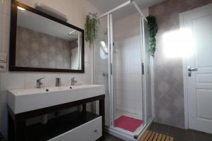 a bathroom with a sink and a shower at Gîte G40 in Marchésieux