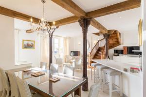 a dining room and living room with a table and chairs at Gîte G4 in Barfleur