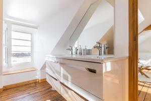 a bathroom with a sink and a mirror at Gîte G4 in Barfleur +13 photos